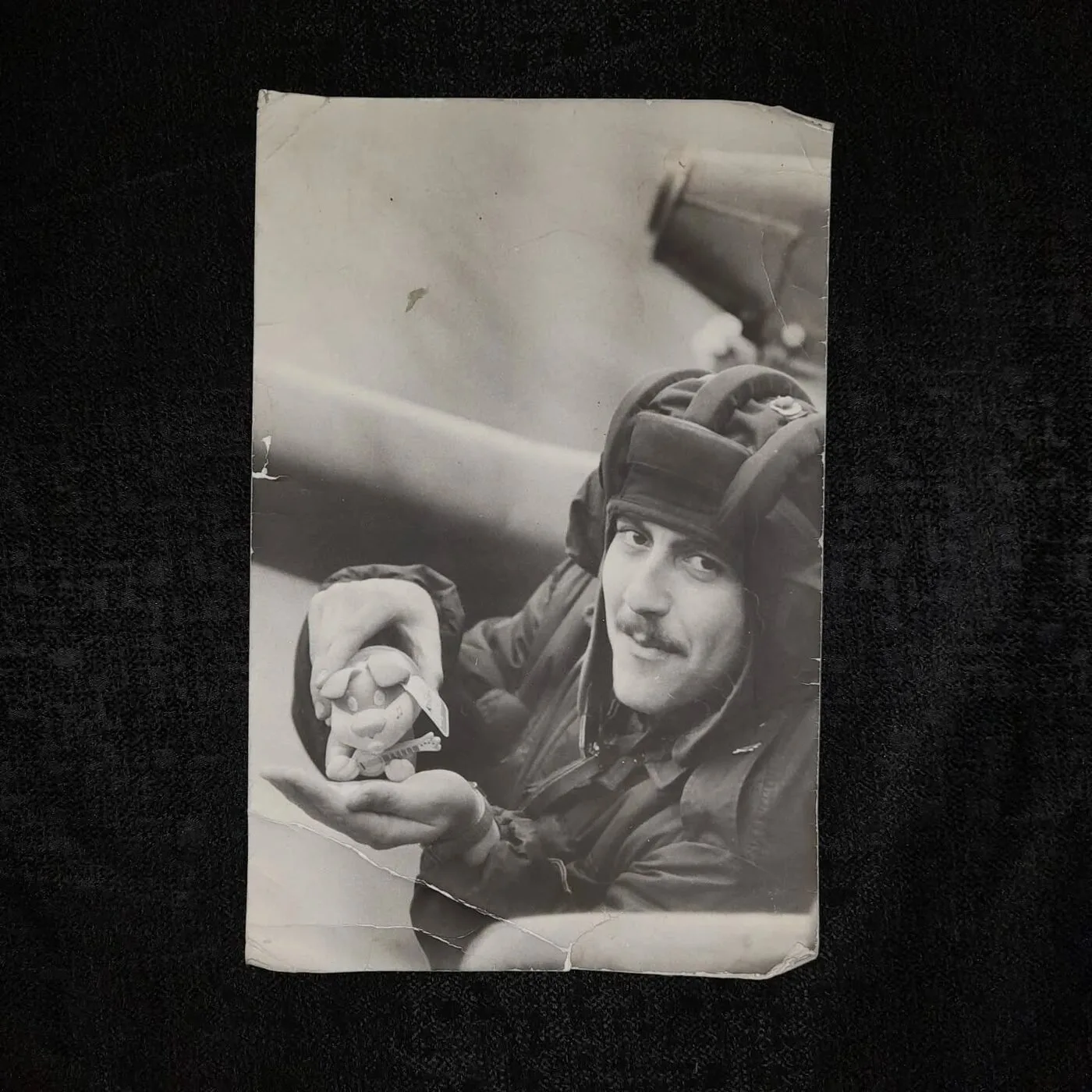 Photo of a tank crewman holding a toy