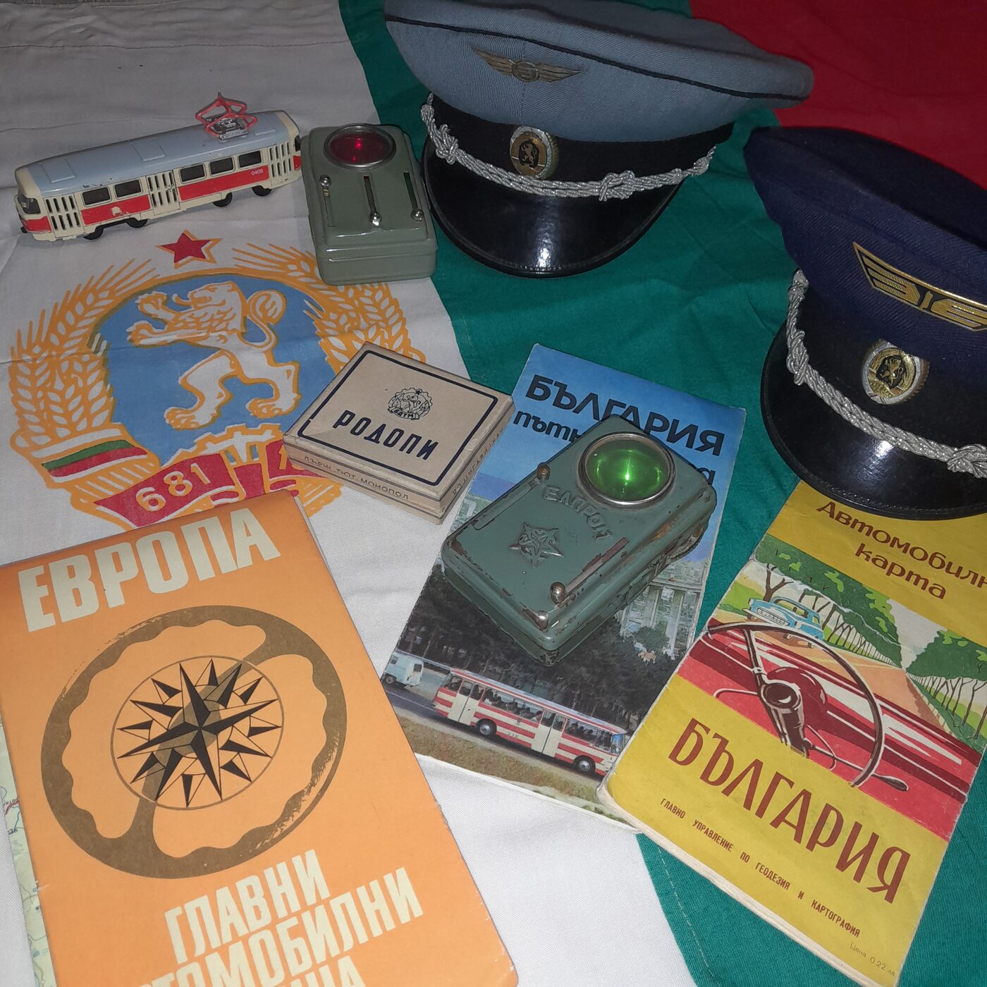 Everyday objects in the People's Republic of Bulgaria: road maps, transport staff caps, miniature tram, cigarettes and torch